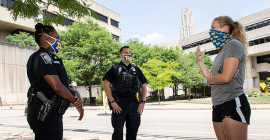 student talks to pitt police officers